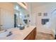 Bathroom featuring a double sink vanity with a large mirror, and shower with curtain at 9590 W Bajada Rd, Peoria, AZ 85383