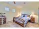 Bedroom with natural light, ceiling fan, tile floors, and a dresser with woven drawers at 9590 W Bajada Rd, Peoria, AZ 85383