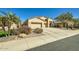 Charming front exterior featuring a three-car garage, desert landscaping, and a well-maintained front yard at 9590 W Bajada Rd, Peoria, AZ 85383