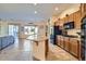 Bright, open kitchen featuring custom cabinets, granite countertops, and an island with a sink at 9590 W Bajada Rd, Peoria, AZ 85383