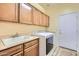 Laundry room with a sink, upper cabinets, a washer, and a dryer at 9590 W Bajada Rd, Peoria, AZ 85383