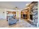 Cozy living room with a stone fireplace, neutral tones, and a comfortable sectional sofa at 9590 W Bajada Rd, Peoria, AZ 85383