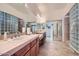 Bathroom featuring a double vanity, framed mirrors, glass block accents, and walk-in closet at 9590 W Bajada Rd, Peoria, AZ 85383