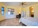 Bright main bedroom with a ceiling fan, desk, and doorway to the bathroom at 9590 W Bajada Rd, Peoria, AZ 85383