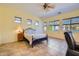 Spacious main bedroom with tile floors, large windows, and ceiling fan with light at 9590 W Bajada Rd, Peoria, AZ 85383