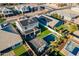 Aerial view of home featuring a sparkling pool, outdoor kitchen, lush landscaping, solar panels, and tile roof at 9937 E Harvest Rd, Florence, AZ 85132