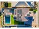 An aerial view of a modern home with solar panels and tile roof overlooking a sparkling pool and cozy outdoor kitchen at 9937 E Harvest Rd, Florence, AZ 85132