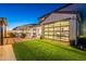 View of back of property showing a basketball court, dining area, and multi-slide doors leading to the interior at 9937 E Harvest Rd, Florence, AZ 85132