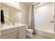 This bathroom features a single vanity with a large mirror over it. Subway tiles line the shower and walls at 9937 E Harvest Rd, Florence, AZ 85132