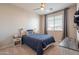 This charming bedroom is awash in sunlight from the bright window and features a ceiling fan and truck-themed pillows at 9937 E Harvest Rd, Florence, AZ 85132