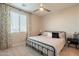 This charming bedroom is awash in sunlight from the bright window and features curtains and overhead fan at 9937 E Harvest Rd, Florence, AZ 85132