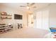 This bedroom is currently being used as a playroom. It features wood shelving and several bins for toys at 9937 E Harvest Rd, Florence, AZ 85132