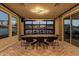 Modern dining room featuring a large table, sleek chairs, and a glass garage door to bring the outside in at 9937 E Harvest Rd, Florence, AZ 85132