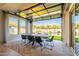 Indoor/outdoor dining space with open glass doors, providing a seamless transition to the backyard and pool at 9937 E Harvest Rd, Florence, AZ 85132