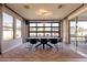 Dining room with large windows, modern light fixture, and access to the backyard through a glass door at 9937 E Harvest Rd, Florence, AZ 85132