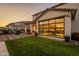 Well-maintained home exterior with a spacious yard, patio, and a unique glass garage door entrance at 9937 E Harvest Rd, Florence, AZ 85132