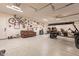 Spacious garage features a speckled floor, ample wall storage, and includes a golf cart and comfortable seating at 9937 E Harvest Rd, Florence, AZ 85132