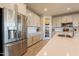 Open kitchen with stainless steel appliances, island sink, and walk-in pantry at 9937 E Harvest Rd, Florence, AZ 85132