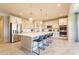 Bright, modern kitchen featuring an island with seating, stainless steel appliances, and pendant lighting at 9937 E Harvest Rd, Florence, AZ 85132