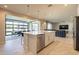 Modern kitchen with an island that opens to the dining room and living room at 9937 E Harvest Rd, Florence, AZ 85132