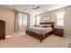 Serene main bedroom with a wooden bed frame, and plush carpeting at 9937 E Harvest Rd, Florence, AZ 85132