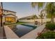 Beautiful backyard pool with modern landscaping and clear blue water, perfect for relaxing and entertaining at 9937 E Harvest Rd, Florence, AZ 85132