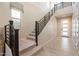 Modern staircase with sleek railings and a bright entryway, leading upstairs at 9937 E Harvest Rd, Florence, AZ 85132