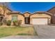 Lovely single-Gathering home with a well-maintained front lawn, a two-car garage, and desert-style landscaping elements at 10004 W Raymond Street St, Tolleson, AZ 85353