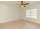 Bedroom with fan, tile floors, and a window offers a clean, minimalist aesthetic at 1052 W Paseo Way, Tempe, AZ 85283