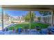 Inviting backyard with a covered patio, lush green lawn, and a sparkling pool, perfect for outdoor living at 11538 W Laurelwood Ln, Avondale, AZ 85392