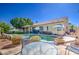 Expansive backyard featuring a pool, covered patio, and lush landscaping, perfect for outdoor enjoyment at 11538 W Laurelwood Ln, Avondale, AZ 85392