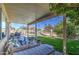 Spacious covered patio with comfortable seating, overlooking the well-maintained backyard and pool area at 11538 W Laurelwood Ln, Avondale, AZ 85392