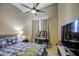 Comfortable bedroom with ceiling fan, carpet and window with light-blocking drapes at 11538 W Laurelwood Ln, Avondale, AZ 85392