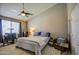 Well-lit bedroom featuring a ceiling fan, comfortable bedding, and stylish decor at 11538 W Laurelwood Ln, Avondale, AZ 85392
