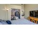 Calm bedroom with open closet and a television on top of a wooden dresser at 11538 W Laurelwood Ln, Avondale, AZ 85392