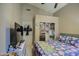 Cozy bedroom with TV, open closet, and en-suite bathroom at 11538 W Laurelwood Ln, Avondale, AZ 85392