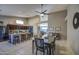 Open-concept dining area and kitchen with stainless steel appliances and bar seating at 11538 W Laurelwood Ln, Avondale, AZ 85392
