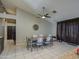 Comfortable dining room with a ceiling fan, seating for six, and beautiful decor at 11538 W Laurelwood Ln, Avondale, AZ 85392