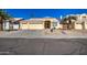 Lovely home exterior featuring desert landscaping, well-lit with a wide driveway, and attached two car garage at 11538 W Laurelwood Ln, Avondale, AZ 85392