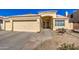 Well maintained house with a two car garage, desert landscape, and a paved walkway to the front door at 11538 W Laurelwood Ln, Avondale, AZ 85392