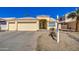 Inviting home exterior with a well-maintained yard and desert landscape, and an attached two car garage at 11538 W Laurelwood Ln, Avondale, AZ 85392