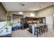 Bright kitchen features dark cabinets, stainless steel appliances, tile flooring, a granite countertop, and a kitchen island at 11538 W Laurelwood Ln, Avondale, AZ 85392