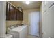 This home has a practical laundry room with tile floors, a washer and dryer, and cabinetry for storage at 11538 W Laurelwood Ln, Avondale, AZ 85392
