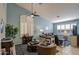 Stylishly decorated living room with vaulted ceilings, plantation shutters, and a cozy seating arrangement at 11538 W Laurelwood Ln, Avondale, AZ 85392