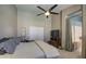 Spacious main bedroom featuring a ceiling fan, comfortable bedding, and ample closet space at 11538 W Laurelwood Ln, Avondale, AZ 85392