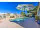 Inviting backyard pool featuring rock accents and a soothing waterfall, creating a serene oasis at 11538 W Laurelwood Ln, Avondale, AZ 85392