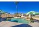Resort-style pool with rock features and clear blue water, creating a relaxing and luxurious outdoor space at 11538 W Laurelwood Ln, Avondale, AZ 85392