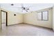 Bedroom with tiled floors, a ceiling fan, and a window providing ample natural light at 1235 E Clearview Dr, Casa Grande, AZ 85122