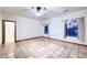 Neutral bedroom with tile floors, windows, and a ceiling fan at 1235 E Clearview Dr, Casa Grande, AZ 85122