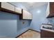 Functional laundry room with upper cabinets, a utility sink and a tiled countertop at 1235 E Clearview Dr, Casa Grande, AZ 85122